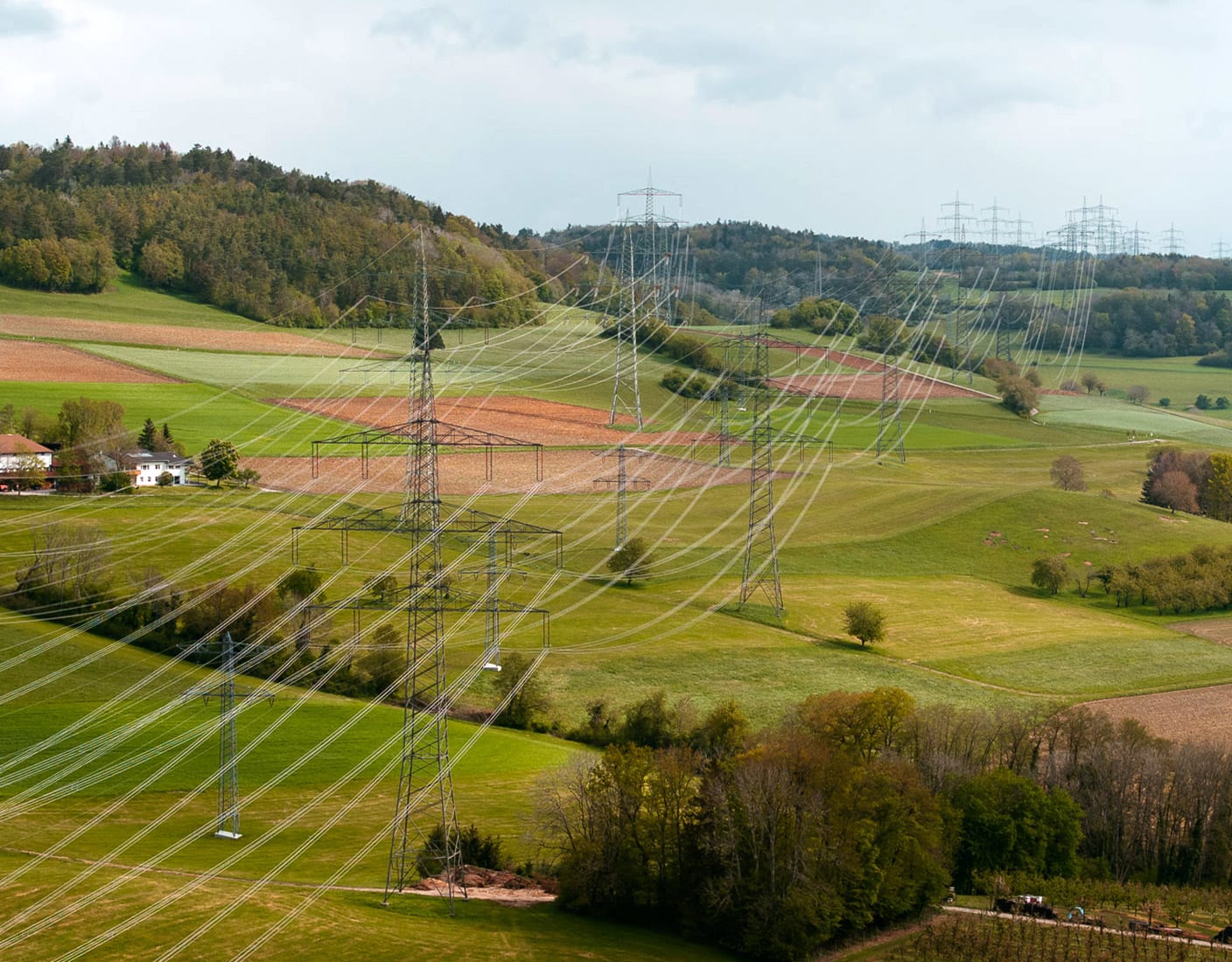 A serene countryside scene featuring electricity pylons.